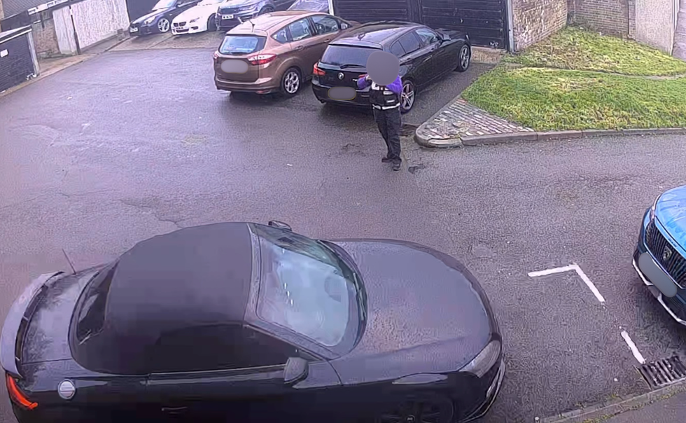 Traffic warden taking photo of the car