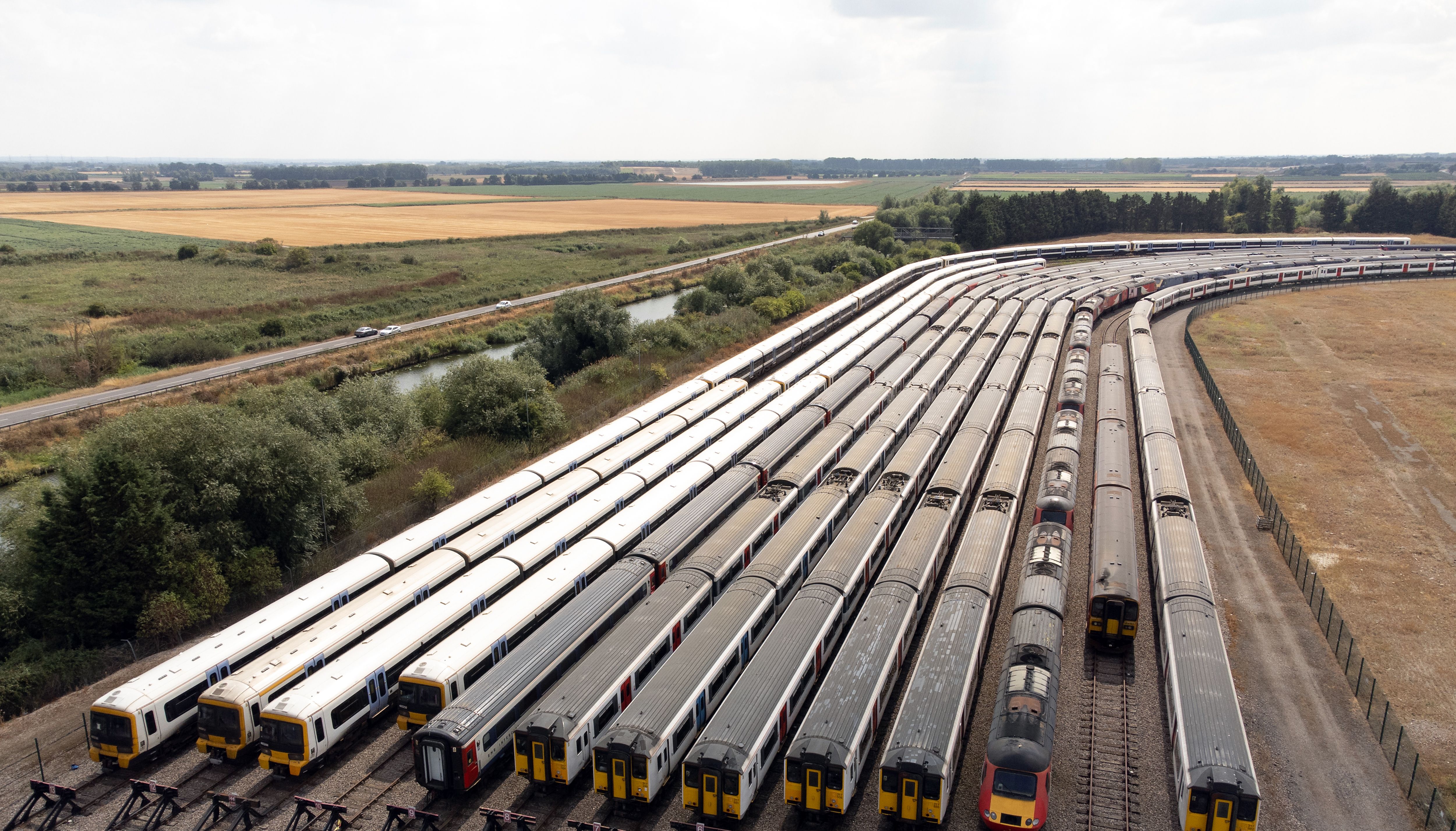 Trains are stored at a sidings in Ely, Cambridgeshire, as rail services have been severely disrupted as members of the Transport Salaried Staffs Association (TSSA) and the Rail, Maritime and Transport (RMT) union strike in a continuing row over pay, jobs and conditions. Picture date: Thursday August 18, 2022.