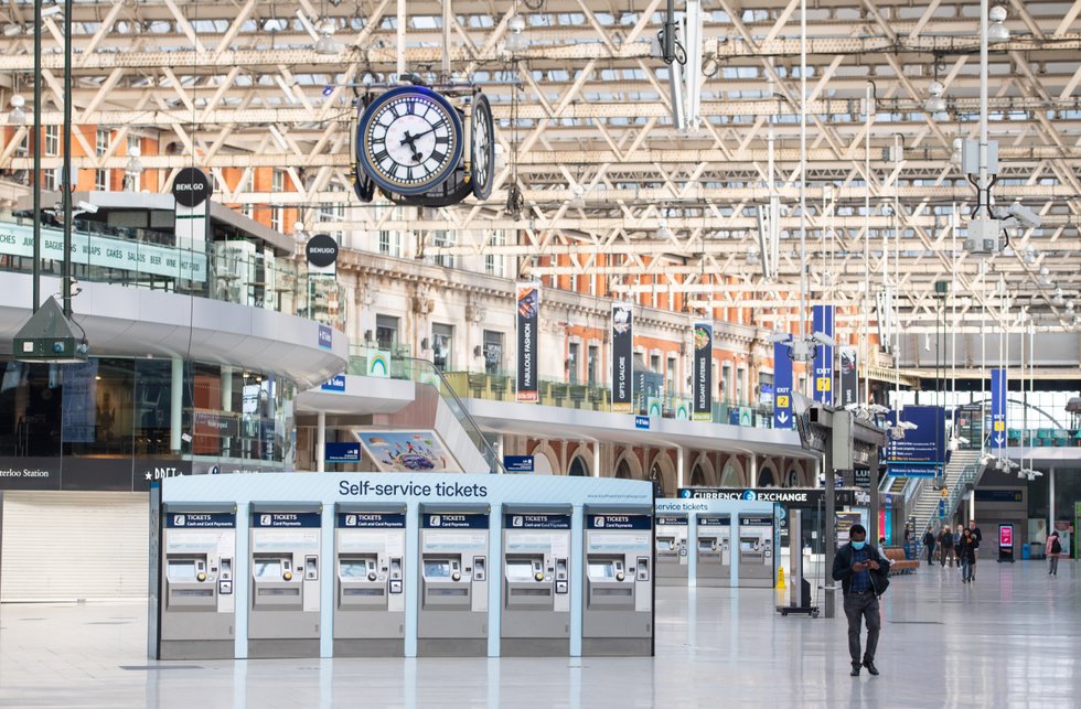 Travellers at a mainly empty Waterloo station, in London, during the pandemic lockdown.