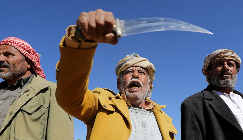Tribal supporter of Yemen's Houthis hold his traditional dagger