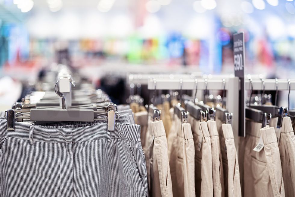 Trousers hanging up in clothes shop