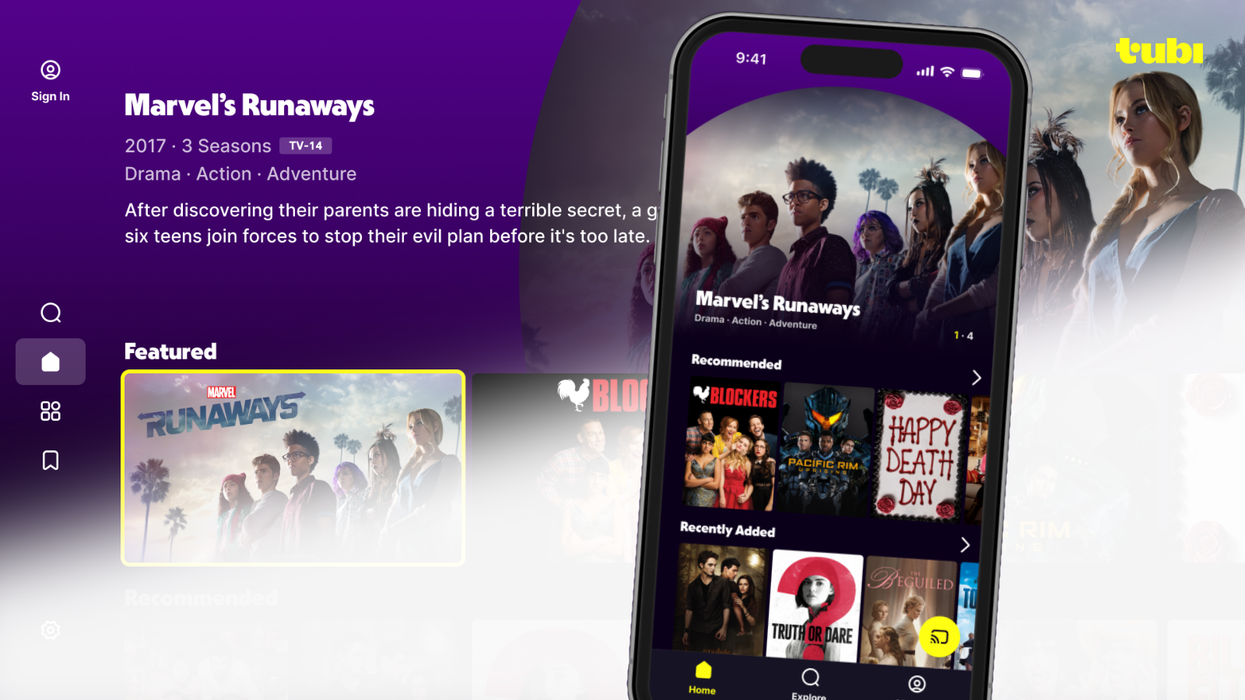 tubi is an ad-supported streaming service pictured on an iPhone with tiles of featured shows in the background too