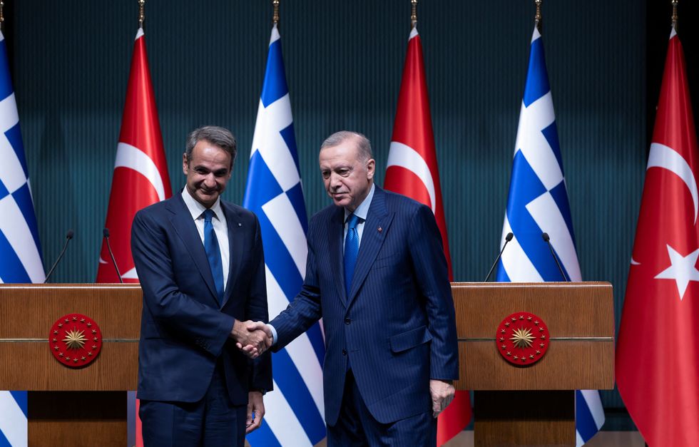 Turkey's President Tayyip Erdogan and Greek Prime Minister Kyriakos Mitsotakis pose after a press conference
