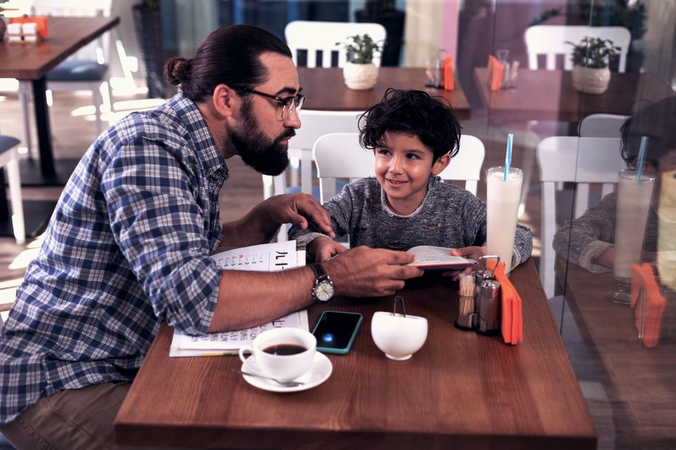 Tutor with child at cafe table