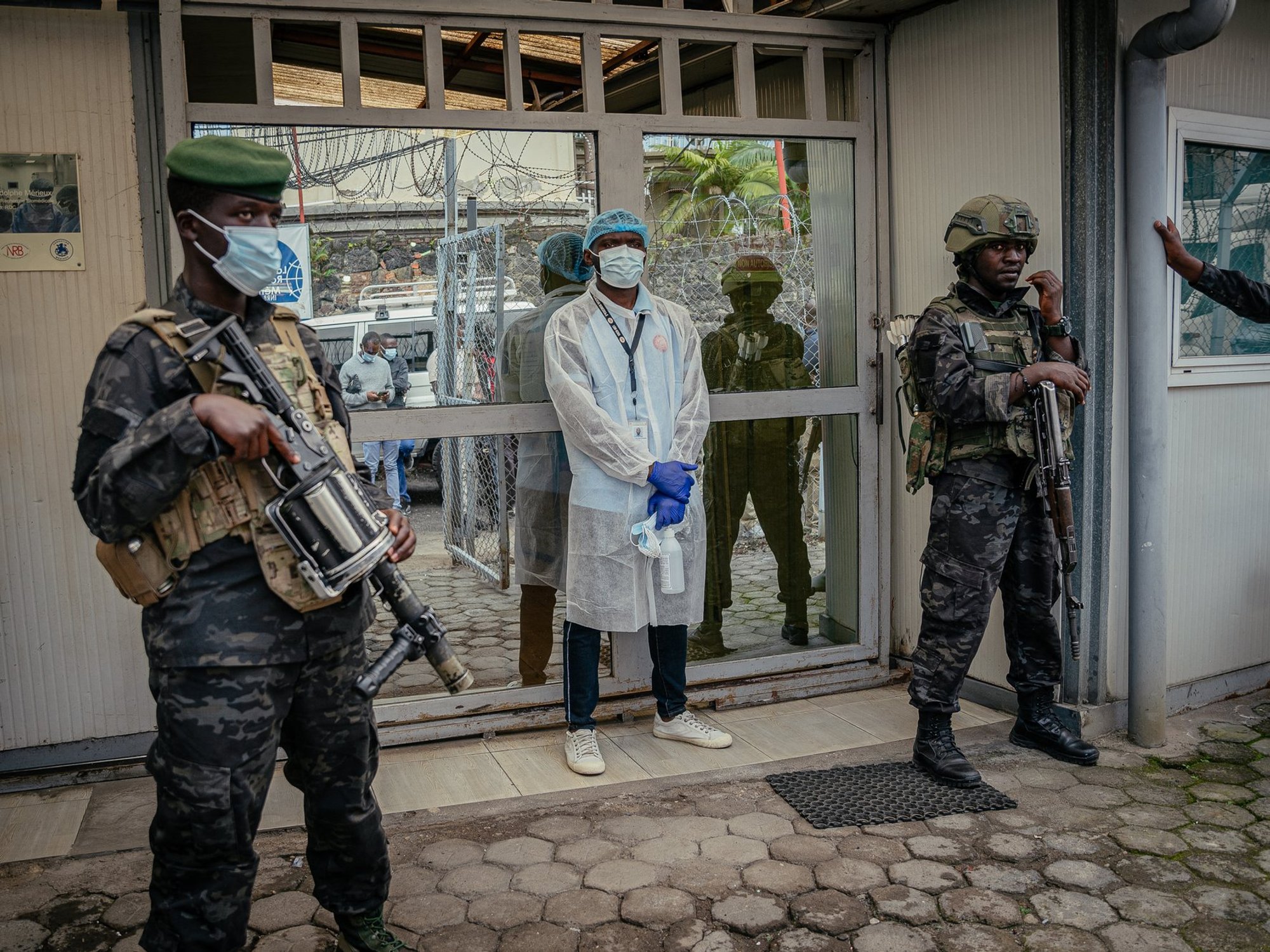 Two armed soldiers outside Democratic Republic of Congo's National Biomedical Research Institute - responsible for analysing and handling Ebola cases - in Goma