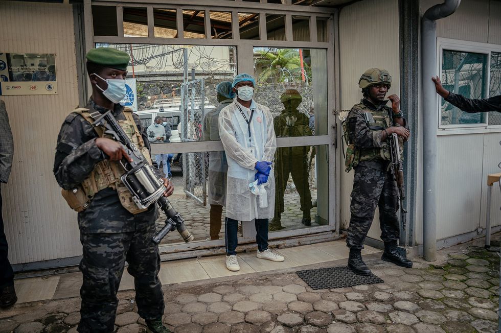Two armed soldiers outside Democratic Republic of Congo's National Biomedical Research Institute - responsible for analysing and handling Ebola cases - in Goma