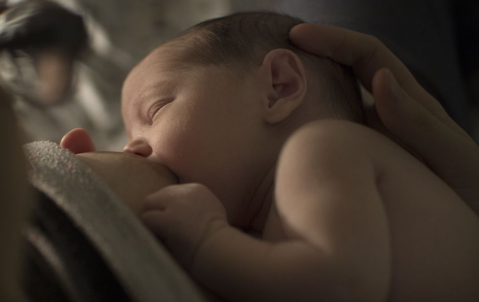 Two-day-old baby girl being breastfed.