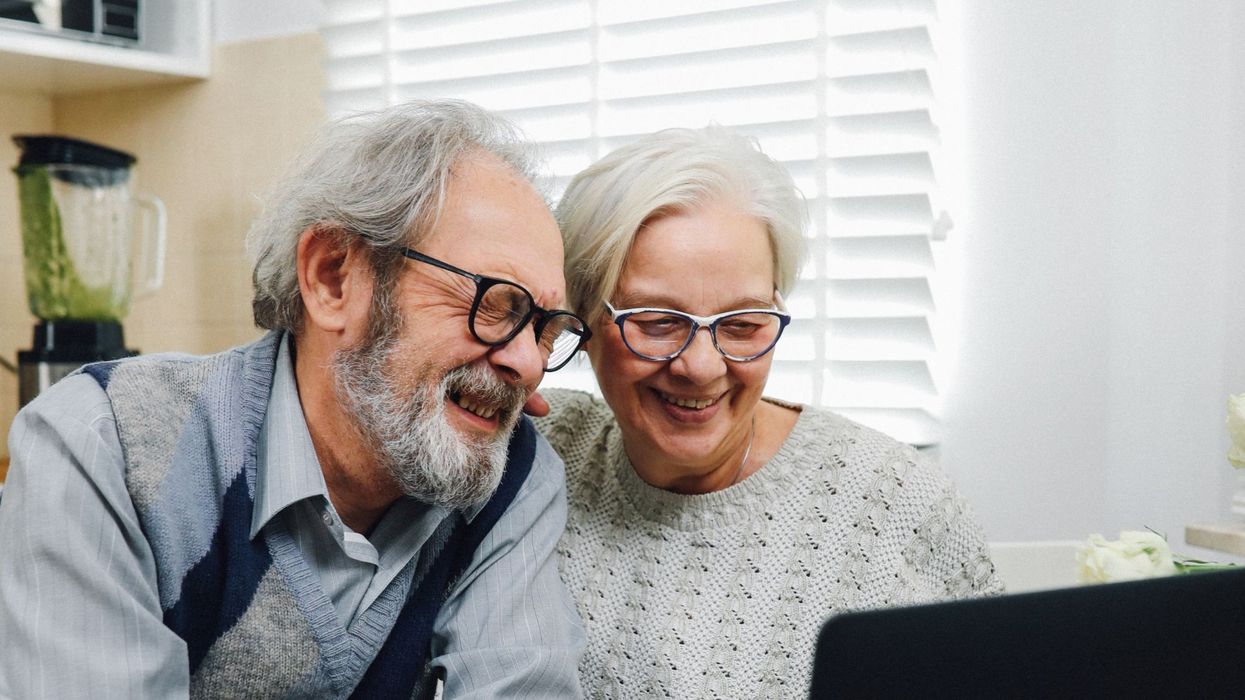 Two pensioners looking at a computer screen