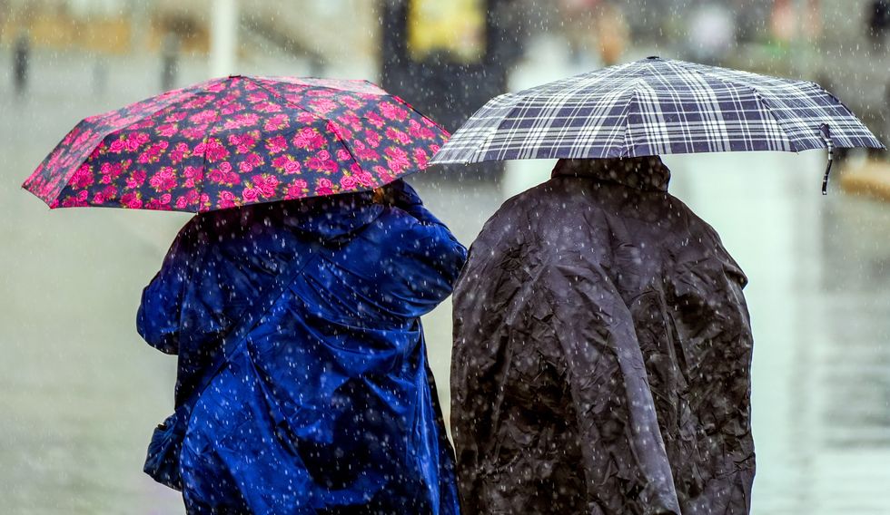 Two people being rained on
