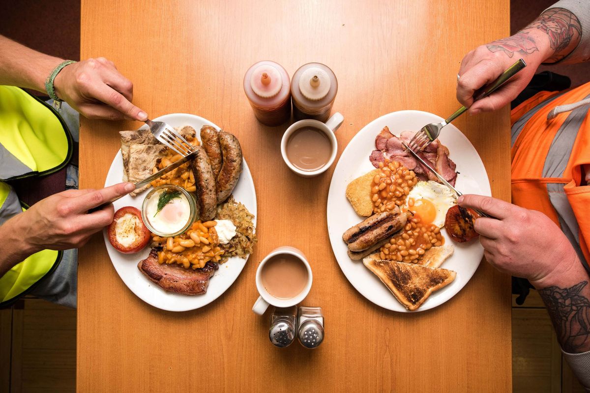 Two people eating an English breakfast
