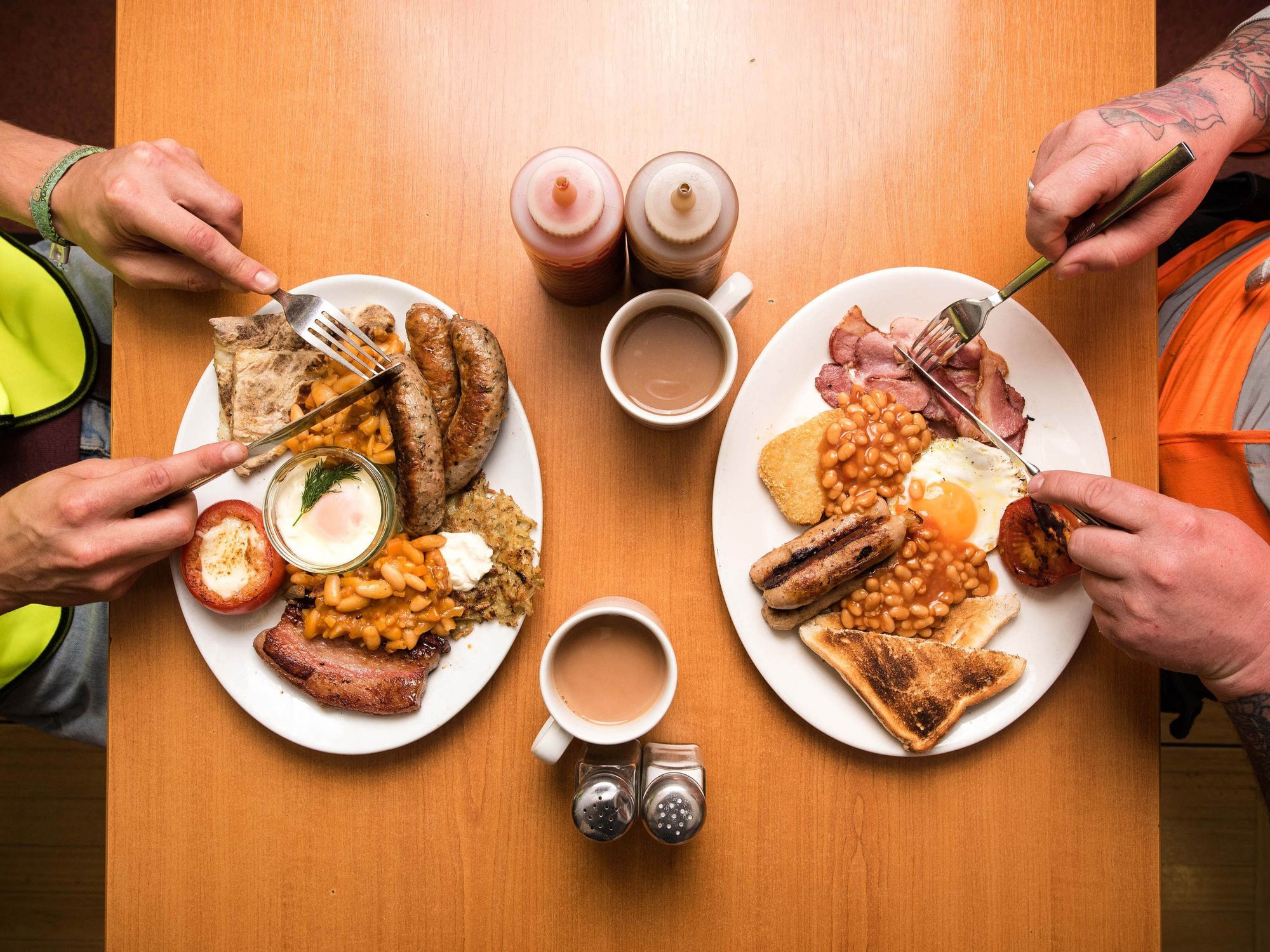 Two people eating an English breakfast