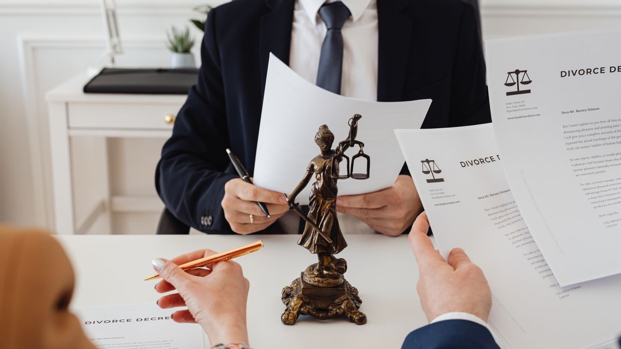 Two people signing divorce papers