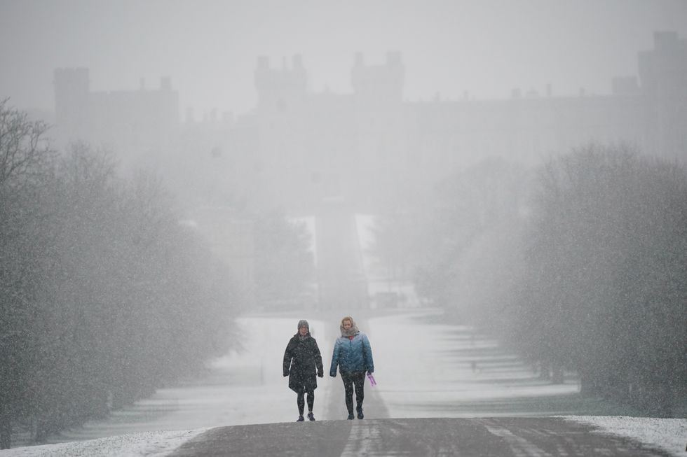 Two people walking through snow