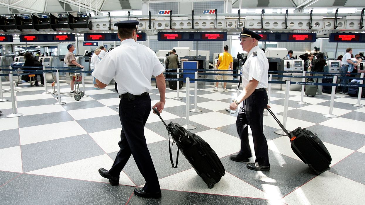Two pilots walk through the United Airlines terminal at O'Hare International Airport May 31, 2005 in Chicago, Illinois