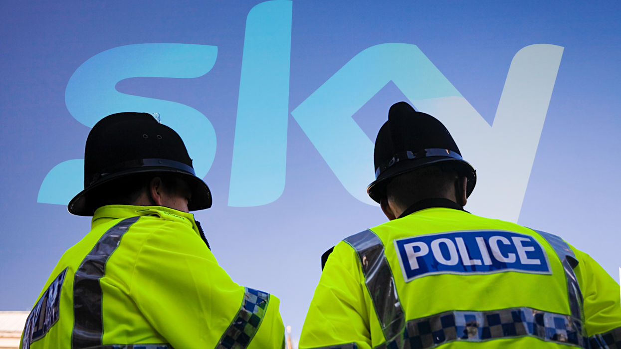 two police officers stand with the sky tv logo