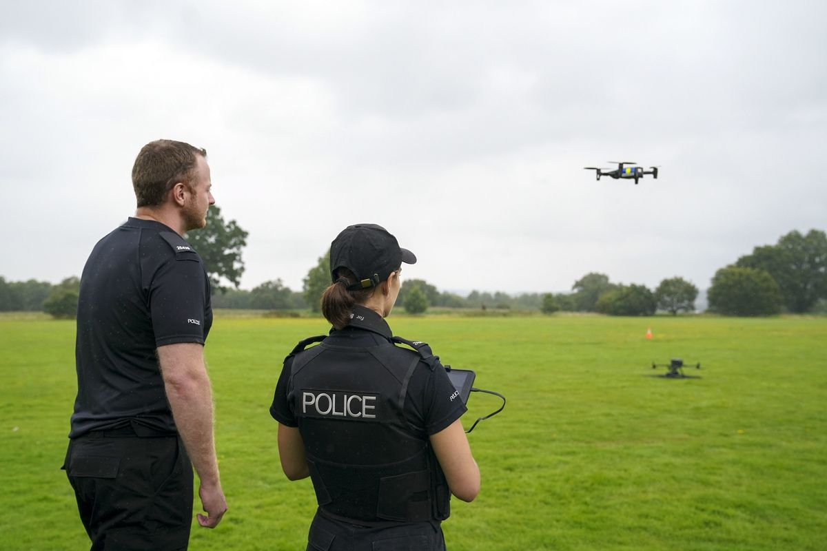 Two police officers using a drone 