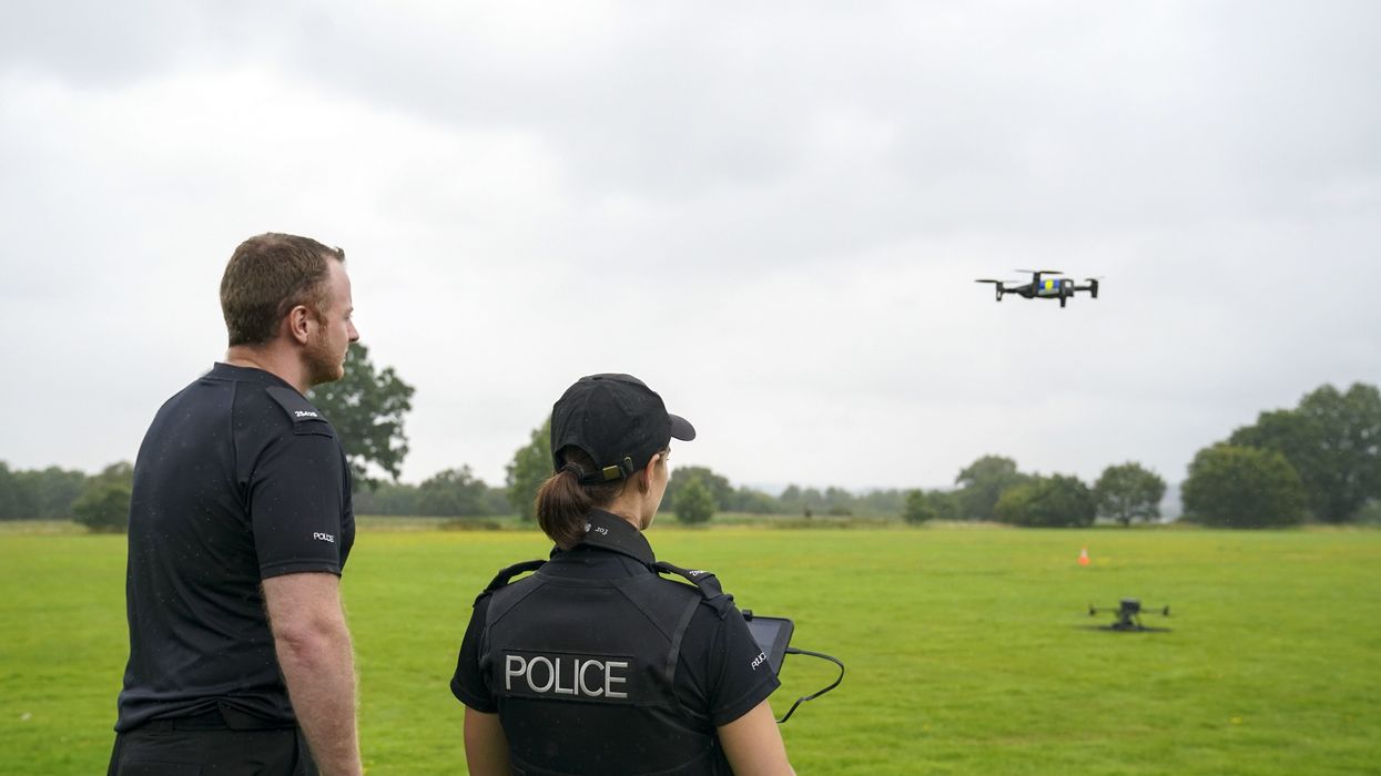Two police officers using a drone