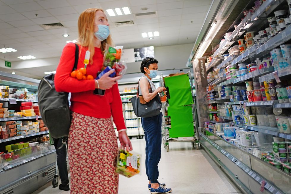 Two shoppers wearing facemasks in a supermarket in East London, during the easing of lockdown restrictions in England. Picture date: Sunday July 4, 2021.