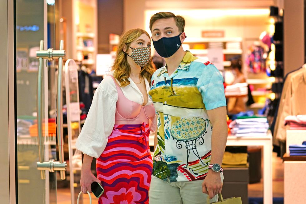 Two shoppers wearing facemasks inside a shopping centre in East London.