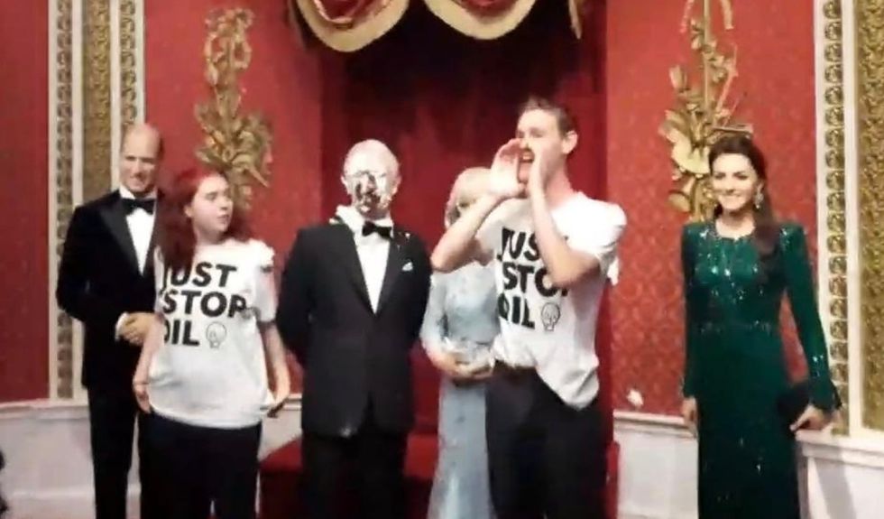 Two supporters of Just Stop Oil have covered a Madame Tussauds waxwork model of King Charles III with chocolate cake