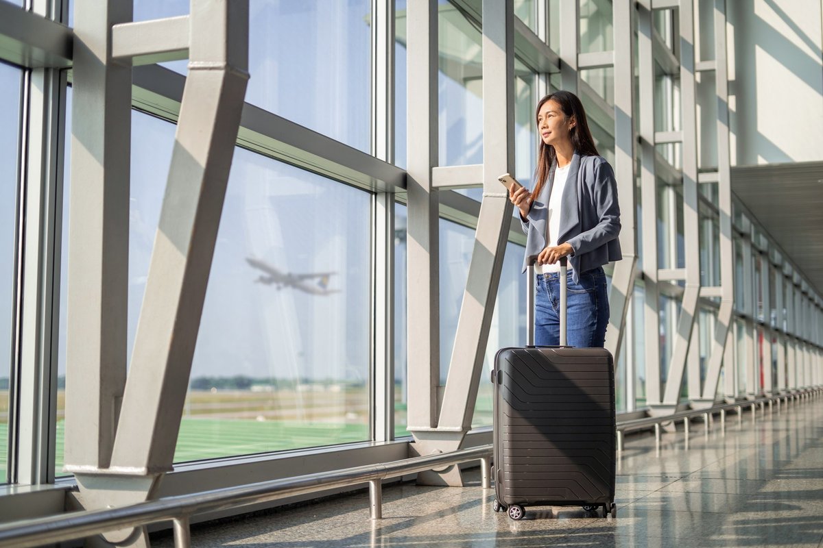 Two women traveling with carry-on luggage
