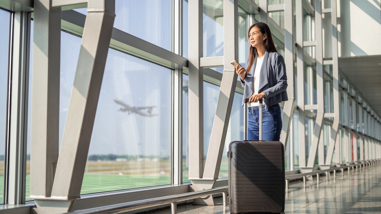 Two women traveling with carry-on luggage