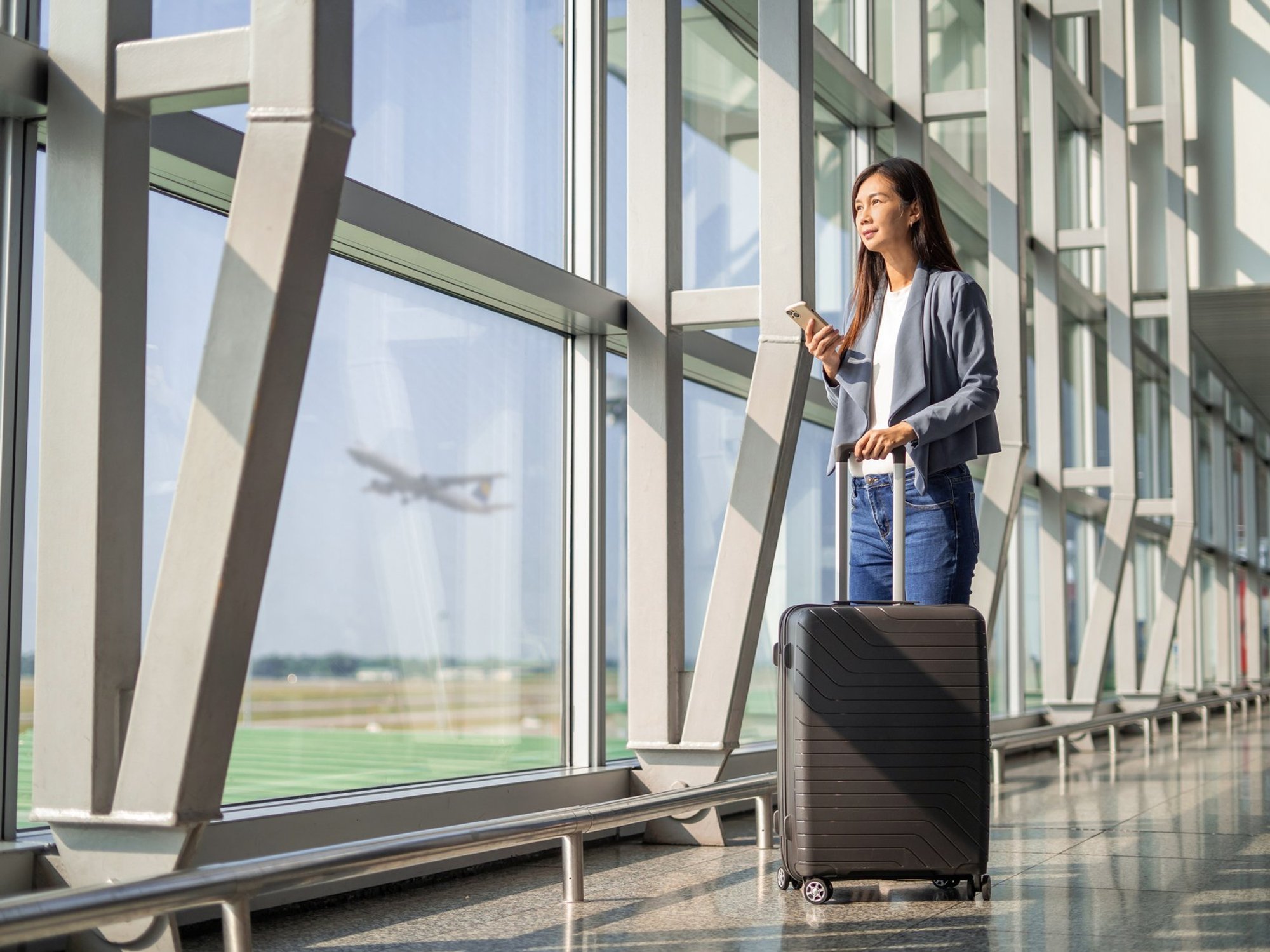 Two women traveling with carry-on luggage
