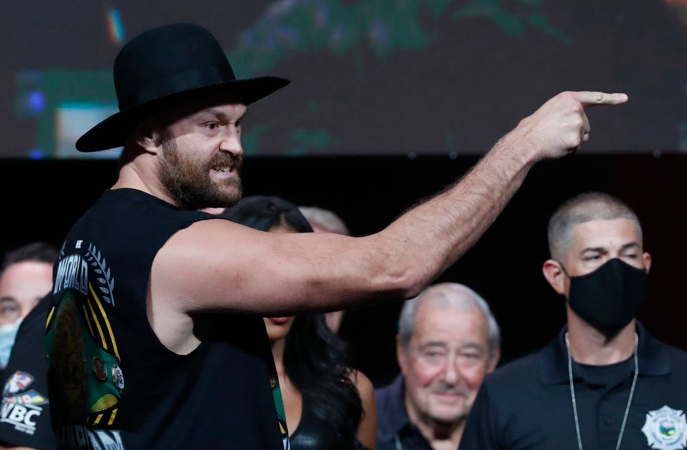 Tyson Fury goads rival Deontay Wilder as he weighed in for his WBC heavyweight title clash against the American.