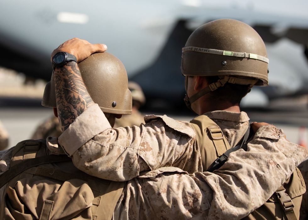 U.S. Marines react during a Ramp Ceremony for service members killed in action during operations at Hamid Karzai International Airport in Kabul, Afghanistan.