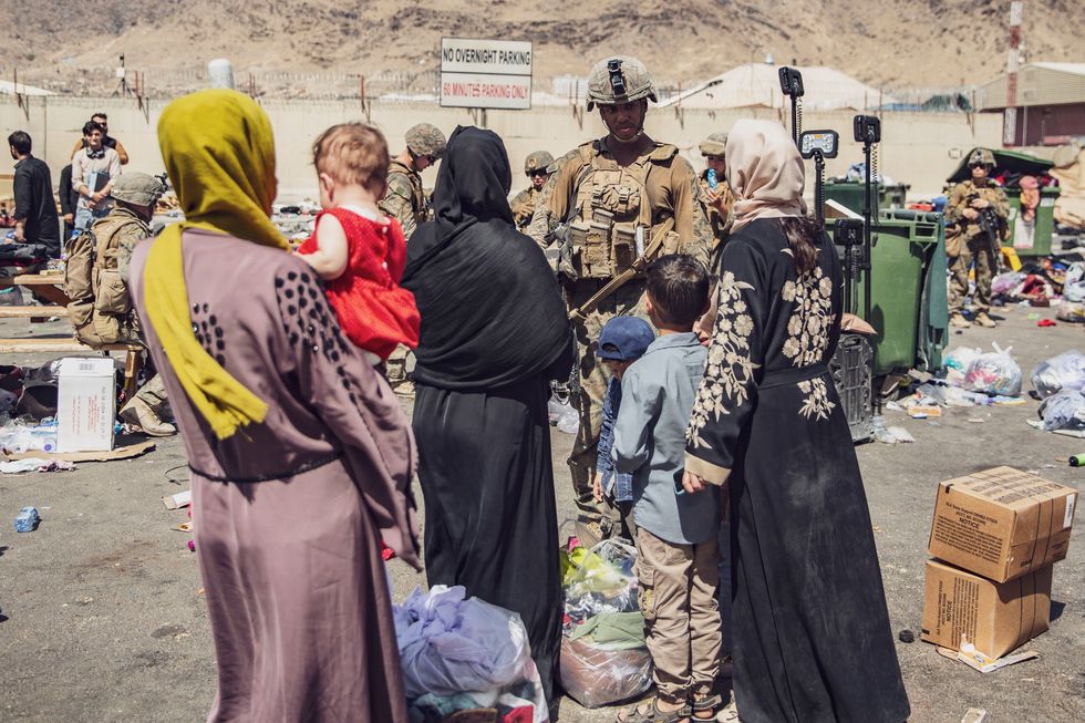 U.S. Marines with the 24th Marine Expeditionary Unit (MEU) process evacuees as they go through the Evacuation Control Center (ECC)