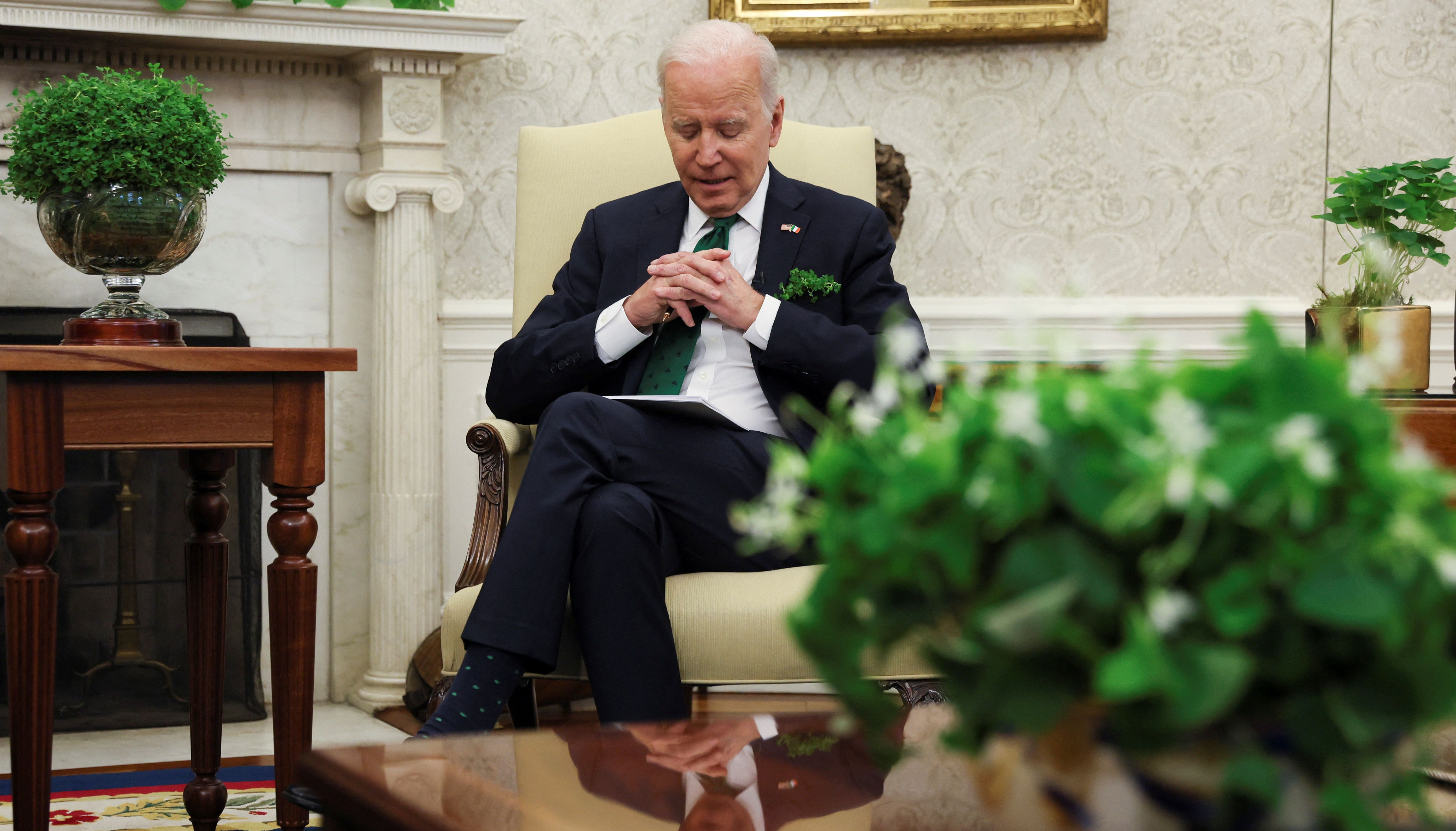 U.S. President Joe Biden hosts a virtual St. Patrick's Day meeting with Ireland's Prime Minister Micheal Martin after Irish Taoiseach Martin tested positive for coronavirus disease (COVID-19) after arriving in Washington, in the Oval Office at the White House in Washington, U.S., March 17, 2022. REUTERS/Leah Millis