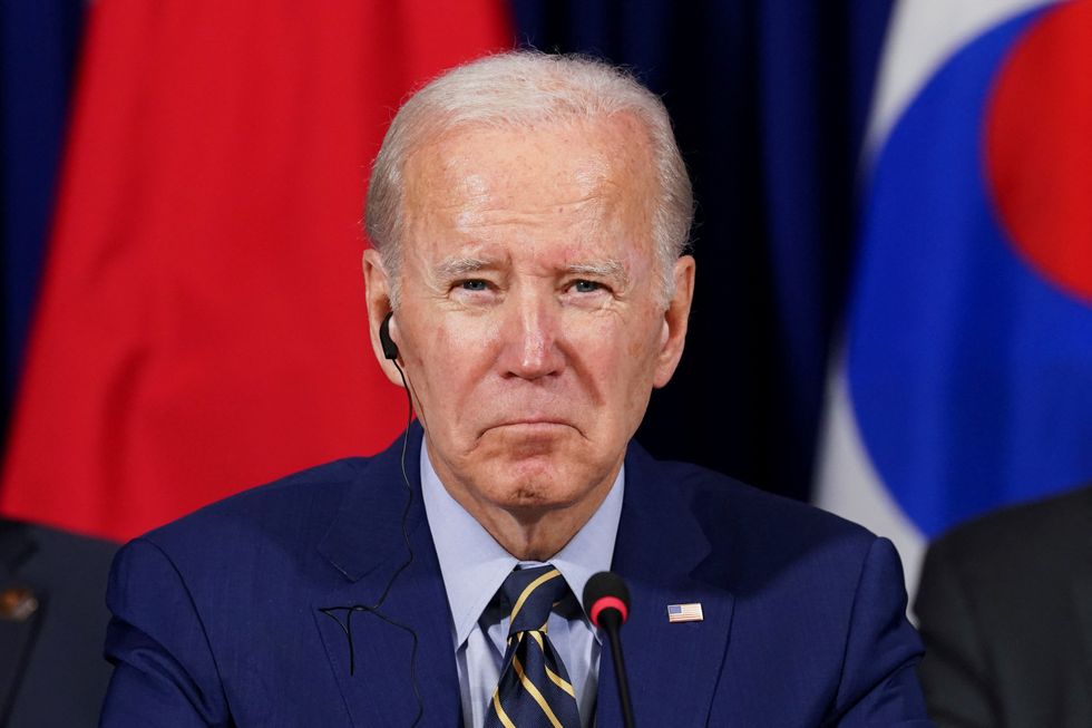 U.S. President Joe Biden looks on as he holds a trilateral meeting with Japanese Prime Minister Fumio Kishida and South Korean President Yoon Suk-yeol in Phnom Penh, Cambodia, November 13, 2022. REUTERS/Kevin Lamarque