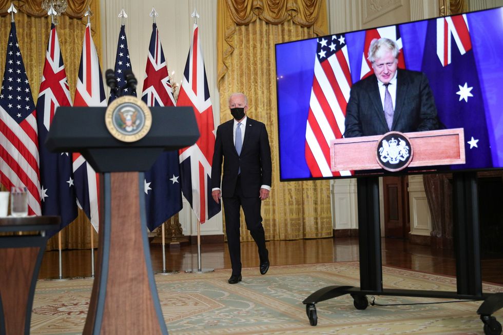 U.S. President Joe Biden walks to the podium before his remarks on a National Security Initiative virtually with Australian Prime Minister Scott Morrison and British Prime Minister Boris Johnson, inside the East Room at the White House in Washington, U.S.