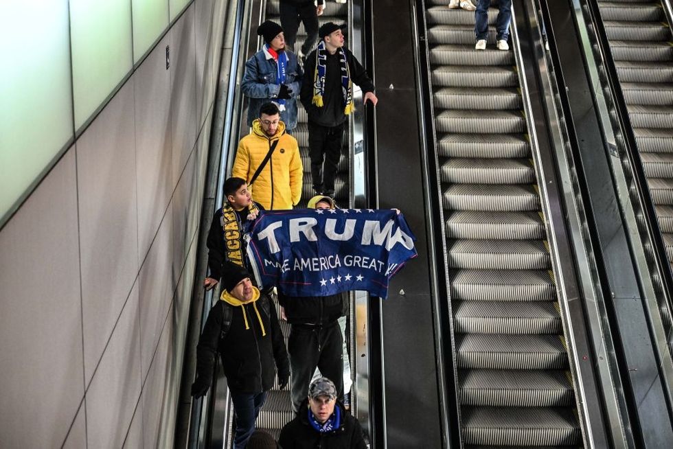 \u200b: A fan opens a Trump banner as fans of Maccabi Tel Aviv stage a pro-Israel demonstration at the Dam Square,