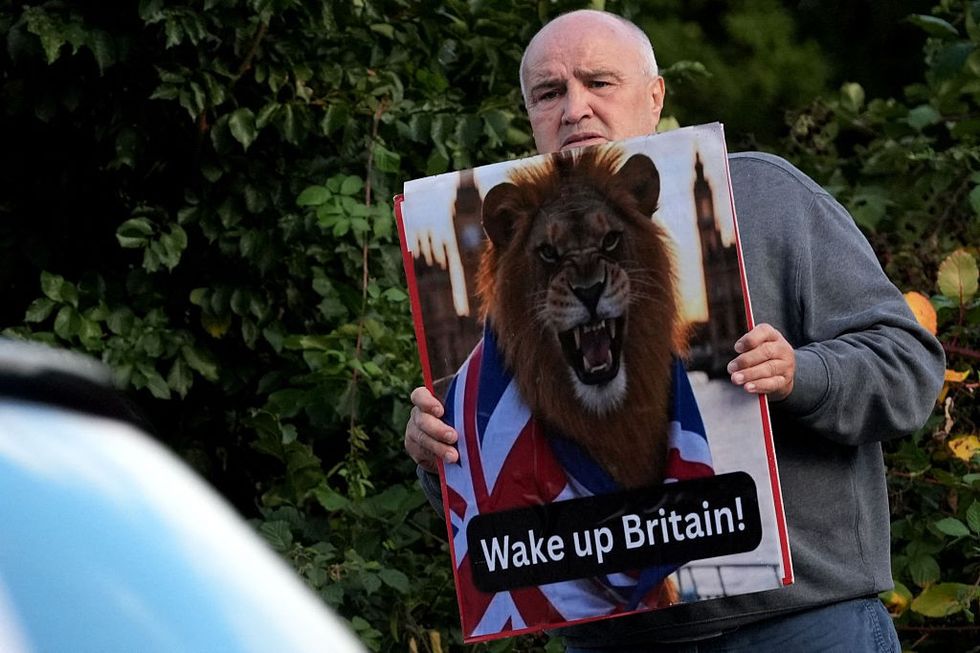 \u200b A protester holds the a sign in Epping after the landmark ruling