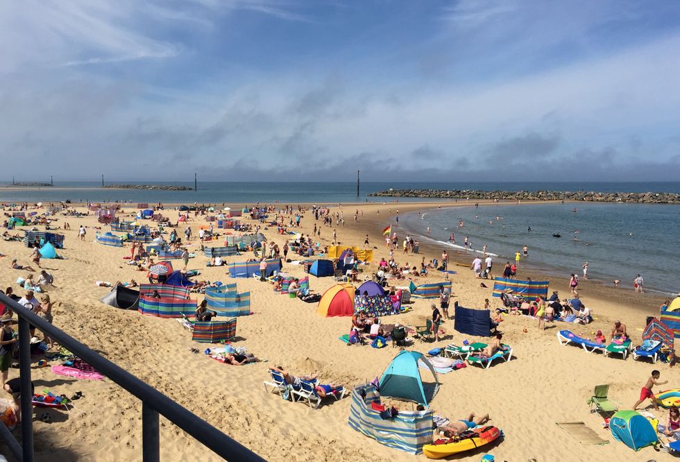 \u200b Beach goers on Sea Palling beach in Norfolk