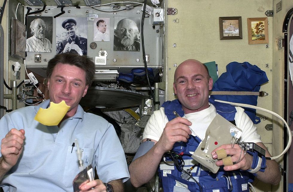 \u200b European Space Agency (ESA) astronaut Andre Kuipers (R) and his NASA colleague Michael Foale eat Dutch cheese for breakfast