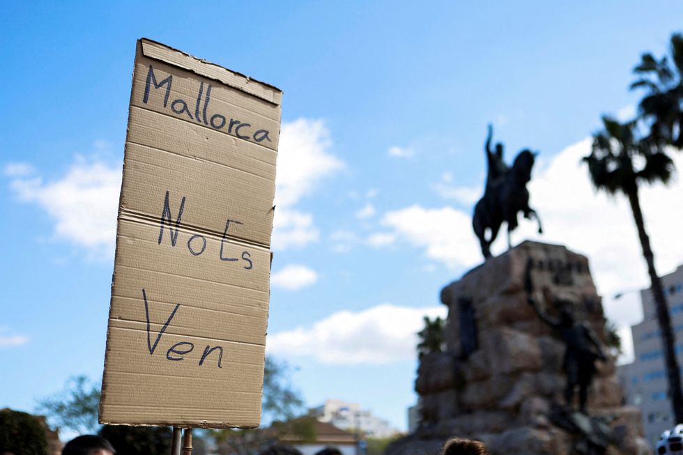 \u200b'Mallorca is not for sale,' reads a protest banner in Plaza Espana, Palma de Mallorca