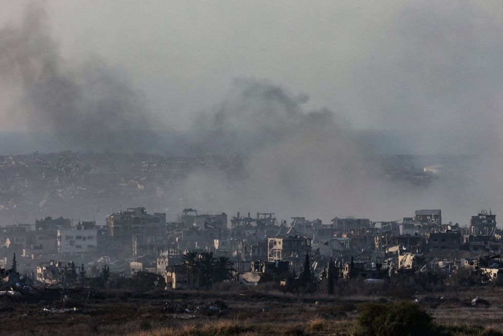 \u200b Smoke rising above destroyed buildings in the northern Gaza Strip during Israeli bombardment