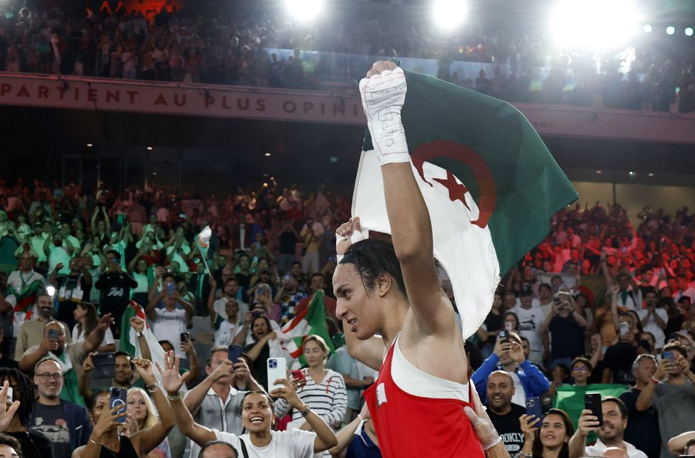 \u200b\u200bImane Khelif hoists the Algerian flag triumphantly
