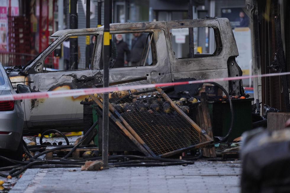 \u200bA burnt out car at the scene of a fire at a mixed commercial and residential premises on Stratford Road in Sparkhill