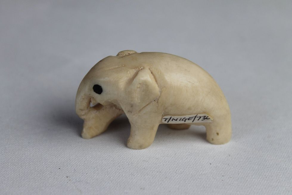 \u200bA carved ivory elephant ornament with inlaid ebony eyes