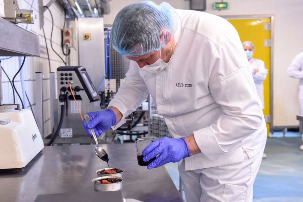 \u200bA chef from French chef Alain Ducasse's team prepares a low-temperature cooked salmon for the French astronaut Thomas Pesquet