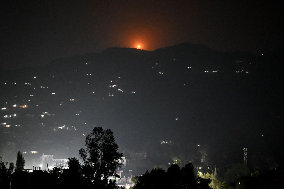 \u200bA flare lights up hills near main town of Poonch district