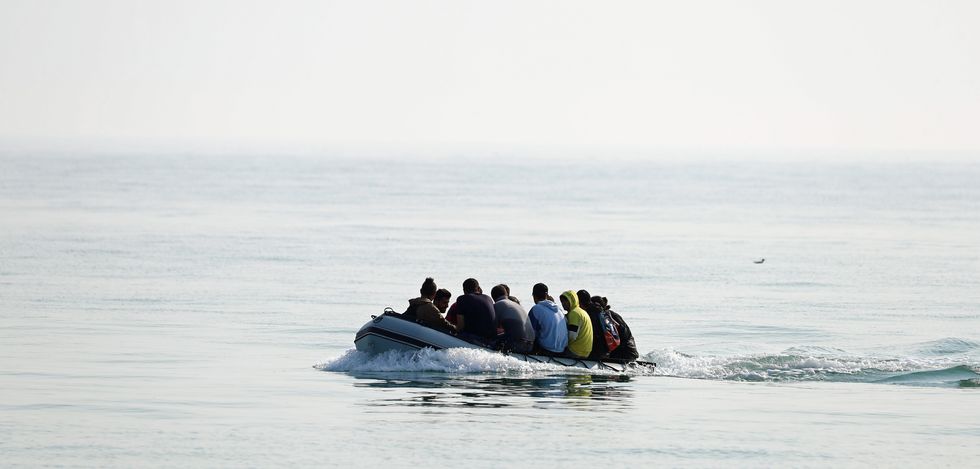 \u200bA group of people thought to be migrants arrive in an inflatable boat at Kingsdown beach, near Dover