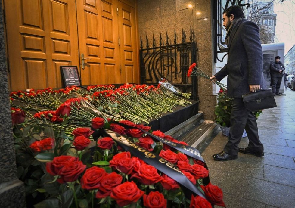 \u200bA man lays flowers to Azerbaijan's Embassy in Moscow