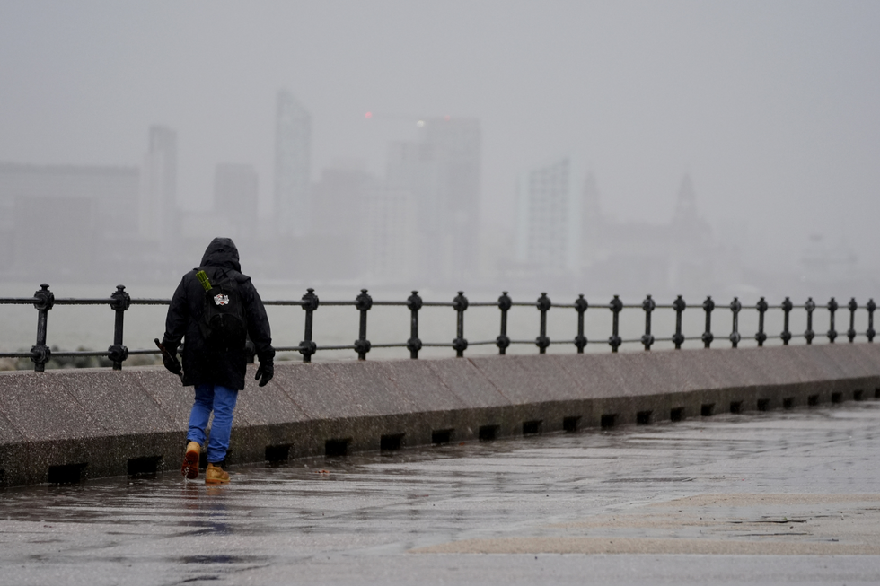 \u200bA man walks along The Promenade New Brighton in Liverpool