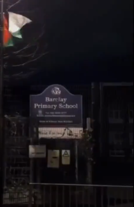 \u200bA Palestinian flag that has been attached to the railings outside the school