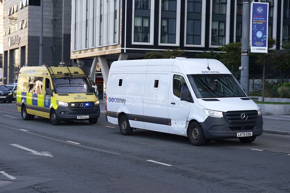 \u200bA prison van escorted by multiple police vehicles arrives at Liverpool Magistrates' Court