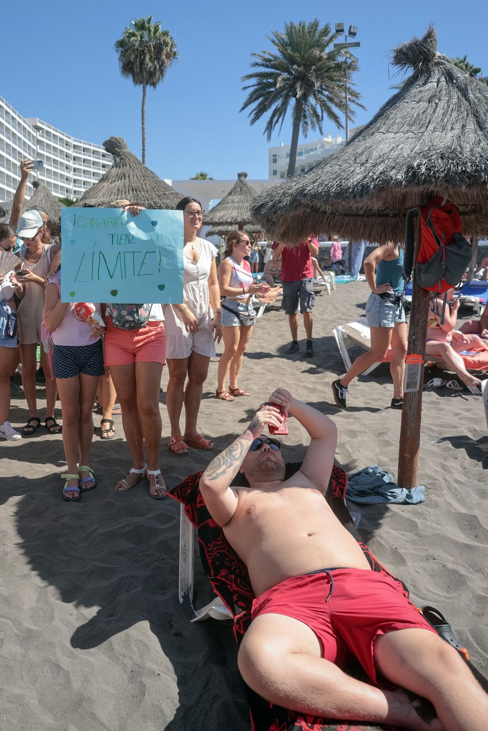 \u200bA protester holds a sign reading 'The Canary Islands have a limit'